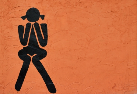 woman sign on orange grunge backgroundの写真素材