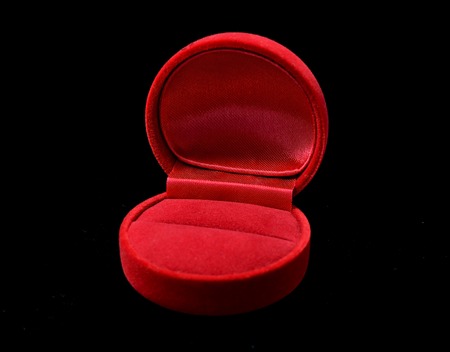 Red jewelry ring box isolated on blackの写真素材