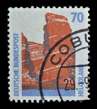 GERMANY - CIRCA 1990 : postage stamp printed in Germany shows red rock of Helgoland, circa 1990のeditorial素材