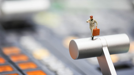 Miniature people : business man looking at watch and walk on the switcher control of Television Broadcast,color buttonsの写真素材