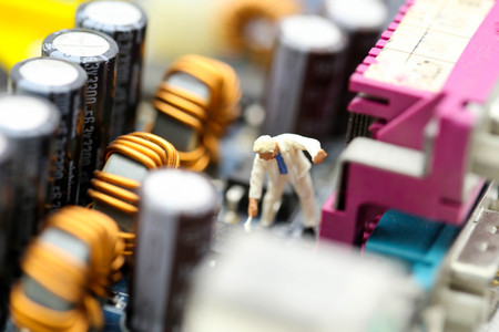 Miniature people : engineer and worker working on computer mainboard bitcoin concept.
