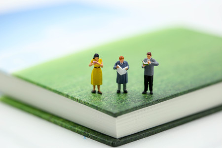 Miniature people : sitting on book using as background education or business concept.の写真素材