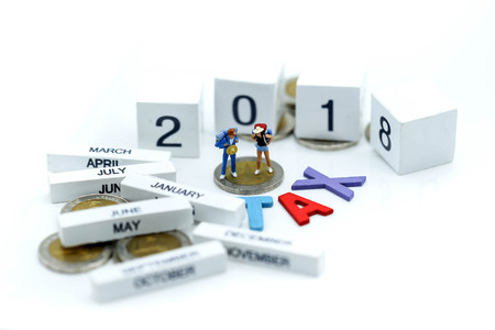 Miniature people travel with wooden of tax and 2018,Business and travel concept.の写真素材