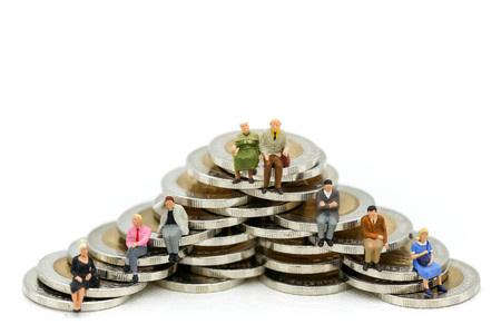Miniature people : sitting on stack of coins. Isolated on white background,Business Financial, money...