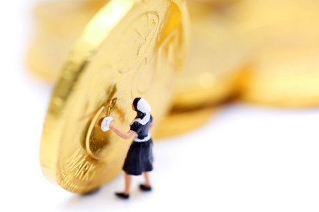 Miniature people : maid cleaning golden coins.の写真素材