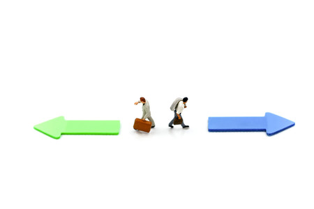 Miniature people: Businessman standing in front of arrow pathway choice using as Business decision...