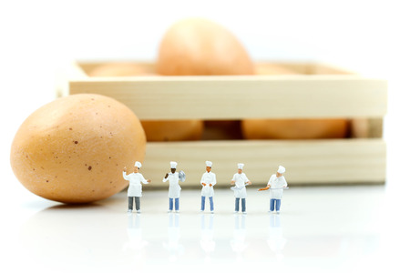 Miniature people : Chef during cooking and working with eggs.の写真素材