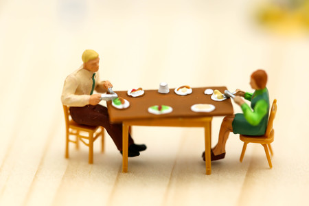 Miniature people : eating together family.の写真素材