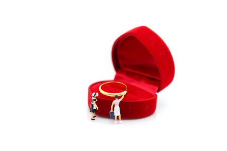 Miniature people : maid cleaning a gold ring , love, valentine day concept.の写真素材