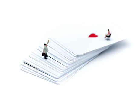 Miniature people : businessman standing on Playing cards.の写真素材