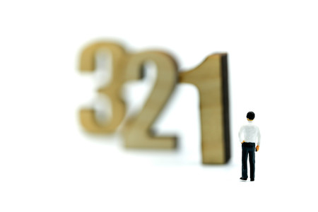 Miniature people : Businessman standing wooden number of 1,2,3