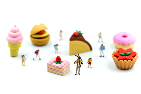 Miniature people : children,student with dessert.fun and food concept.の写真素材