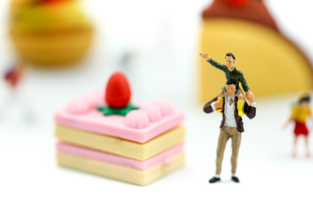Miniature people : children,student with dessert.fun and food concept.の写真素材