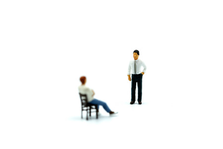 Miniature people : Man sitting a chair with businessman.の写真素材
