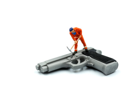 Miniature people : Worker with a gun.の写真素材