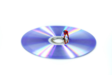 Miniature people : Worker digging a DVDs