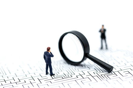 Miniature people: Magnifying glass focusing on the selected of businessman ,recruitment process, HR, HRM, HRD concepts.の写真素材