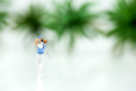 Miniature people : golfer stand with tree background.の写真素材