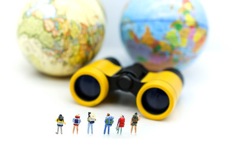 Miniature people : Traveler team with Binoculars and world map background ,trip traveler concept.の写真素材