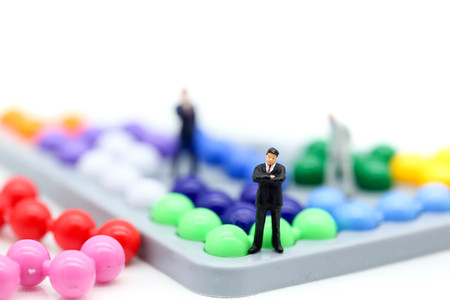 Miniature people : Businessman with Colorful abacus and kids toy,business and education concept.の写真素材