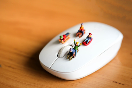 Miniature people : Child  having fun to play slider with computer mouse wireless.の写真素材