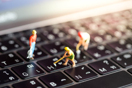 Miniature people : worker team with  button on a computer keyboard.の写真素材