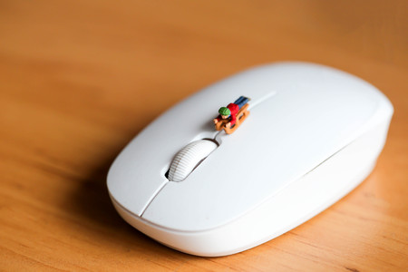 Miniature people : Child  having fun to play slider with computer mouse wireless.の写真素材