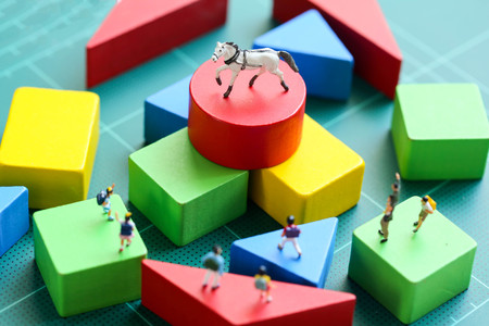 Miniature people : children with wooden block and mini toy horse, Education concept.の写真素材
