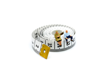 Miniature people : Old people sitting on Tape Measure,Healthcare concept.の写真素材