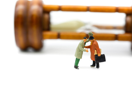 Miniature people : Businessman about to stab his friend,business concept.の写真素材