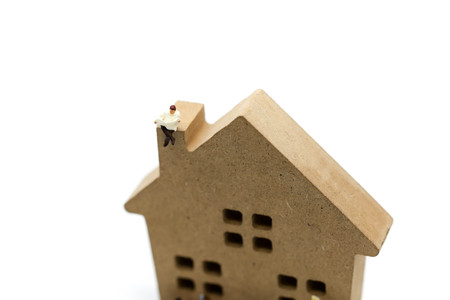 Miniature people : people reading a book  with wooden house toy, Education concept.の写真素材