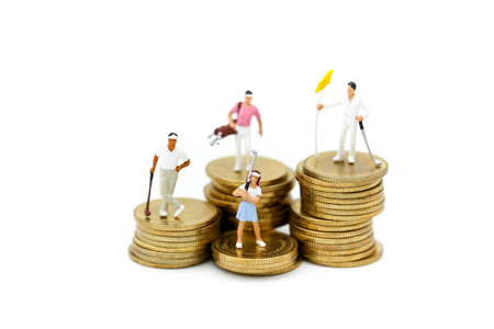 Miniature people : Golfer teams playing stand with stack of coins , sport and business concept.の写真素材