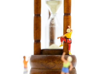 Miniature people : climbing with Sandglass, hourglass.の写真素材