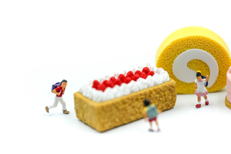 Miniature people : children with  sweet desserts.の写真素材