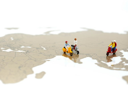Miniature people : people on scooter with world map,Travel concept.の写真素材