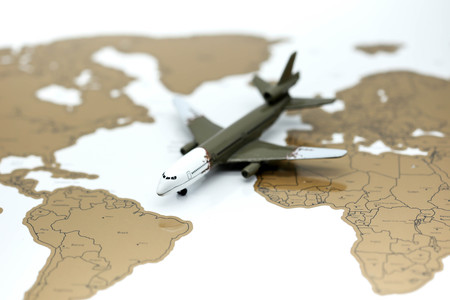 Airplane miniature on world map.の写真素材