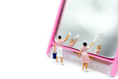 Miniature people : Maid cleaning mirror,housework and housekeeping concept.の写真素材