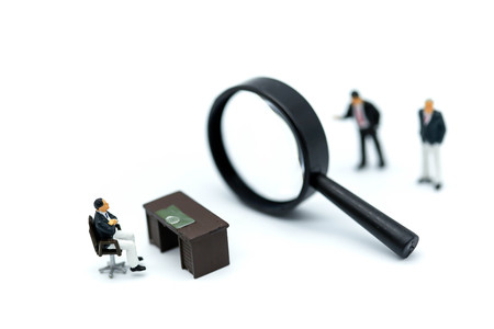 Miniature people: Magnifying glass focusing on the selected of businessman ,recruitment process, HR, HRM, HRD concepts.の写真素材