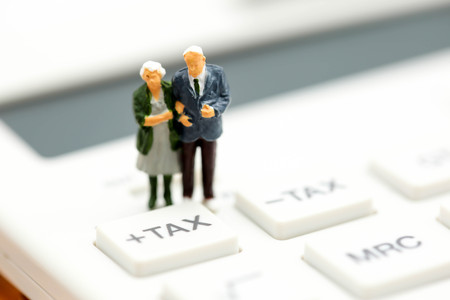Miniature people : Couple oldman standing with Calculator,business,tax concept.
