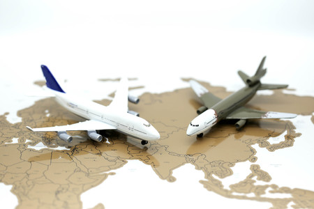 Airplane miniature on world map.の写真素材