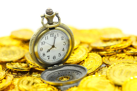 Vintage Pocket watch on gold coins.の写真素材
