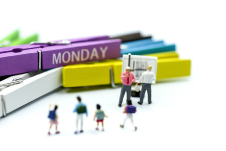 Miniature people : children and teacher with Colorful wooden pinch of list everyday.
