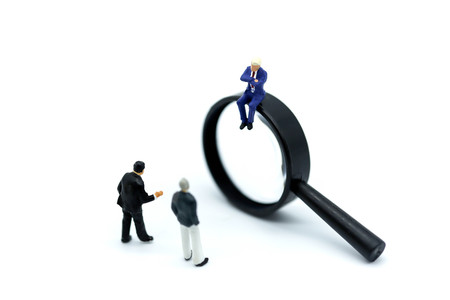Miniature people: Magnifying glass focusing on the selected of businessman ,recruitment process, HR, HRM, HRD concepts.の写真素材