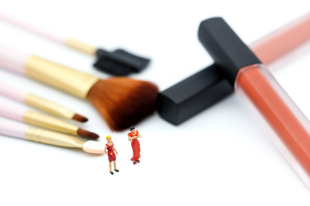 Miniature people: womans and friend sitting on cosmetic bottle using as background business, healthcare and beauty concept.の写真素材