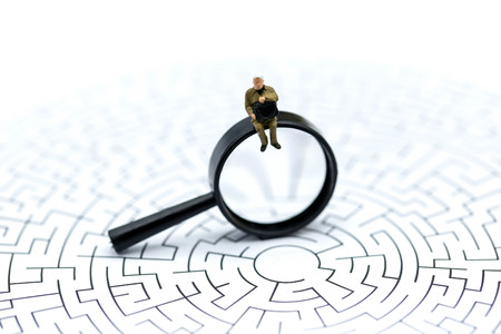 Miniature people: Magnifying glass focusing on the selected of businessman ,recruitment process, HR, HRM, HRD concepts.の写真素材