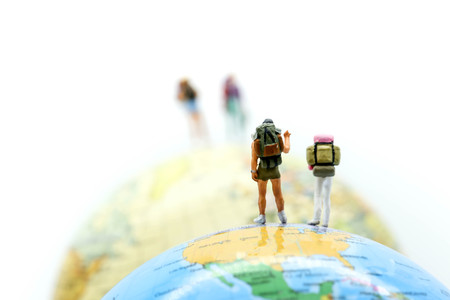 Miniature people : traveler  with world map, backpack and travel concept.の写真素材