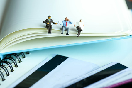 Miniature people : reading stand on book using as background education or business concept.の写真素材