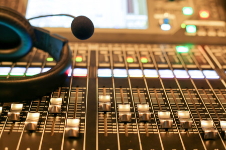 Professional audio Mixer and Professional Headphones in the Recording Studio. Sound Mixing Desk....