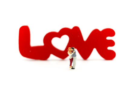 Miniature people : Couple of love with wooden block "LOVE"の写真素材