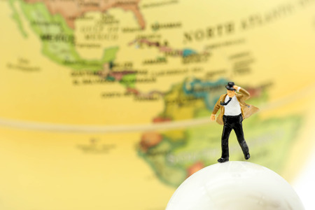 Miniature people : businessman standing with world map,business and travel concept.